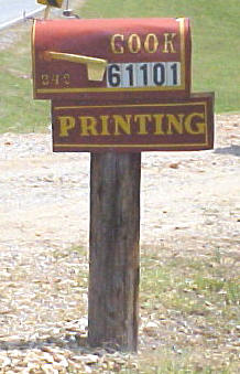 Turn at the red mail box with gold writing "Cook and Printing".