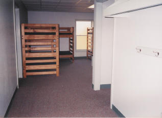 Dorm hall, mini room door to right, bathroom door to left, large room in back.